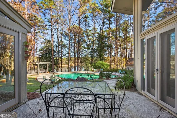 a view of a chair and table in backyard of the house