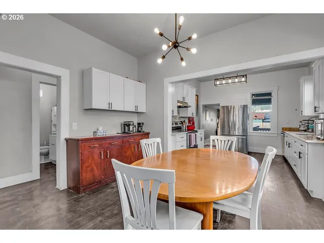 a dining room with furniture window and wooden floor