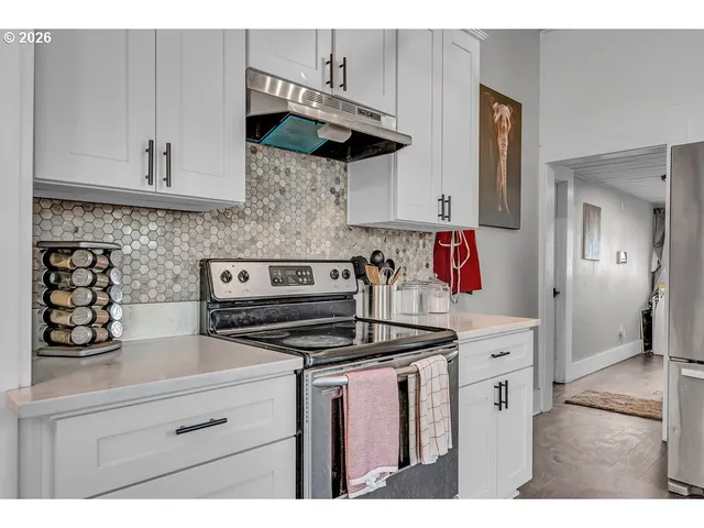 a kitchen with stainless steel appliances granite countertop a refrigerator sink and cabinets