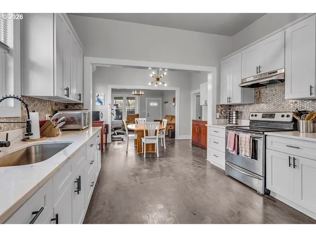 a open kitchen with cabinets a sink and appliances