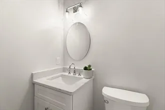 a bathroom with a toilet sink and mirror