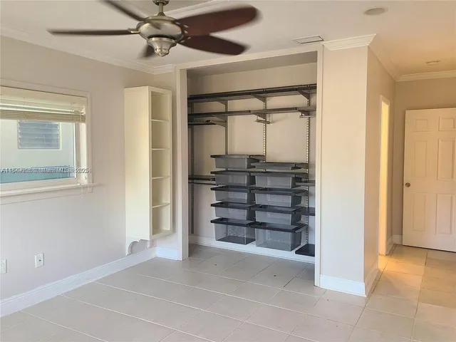 a view of a room with a ceiling fan