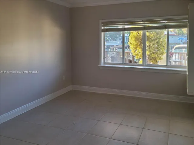 a view of a livingroom with an empty space and a window