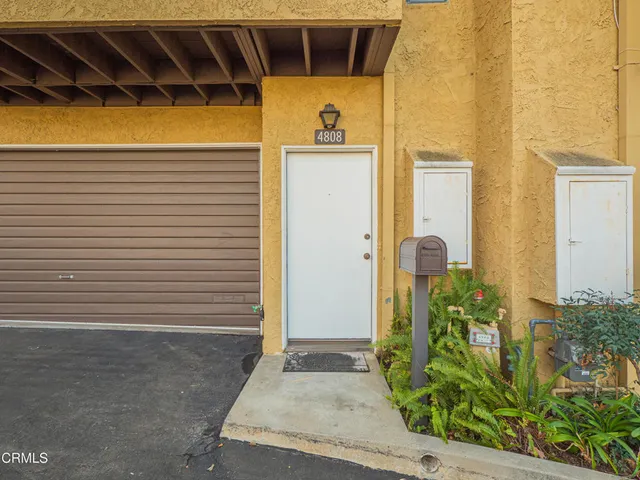 a view of front door of house and car parked