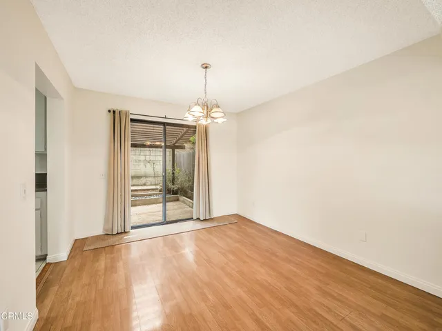 a view of a room with wooden floor closet and a bathroom