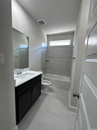 a bathroom with a double vanity sink toilet and shower