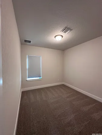 an empty room with a empty space and windows