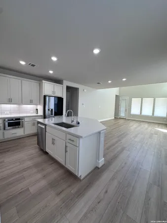 a kitchen with stainless steel appliances granite countertop a wooden cabinets and a sink