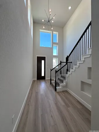 a view of entryway and hall with wooden floor