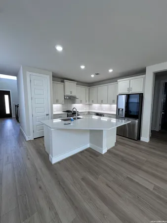 a kitchen with stainless steel appliances kitchen island wooden cabinets and granite counter tops