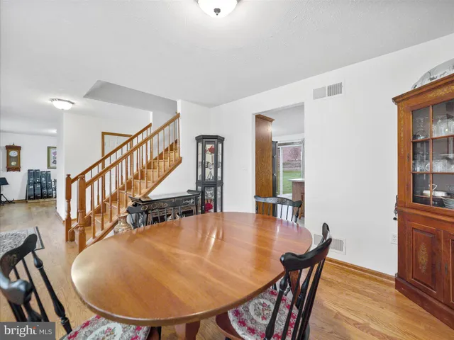 a dining room with furniture and wooden floor