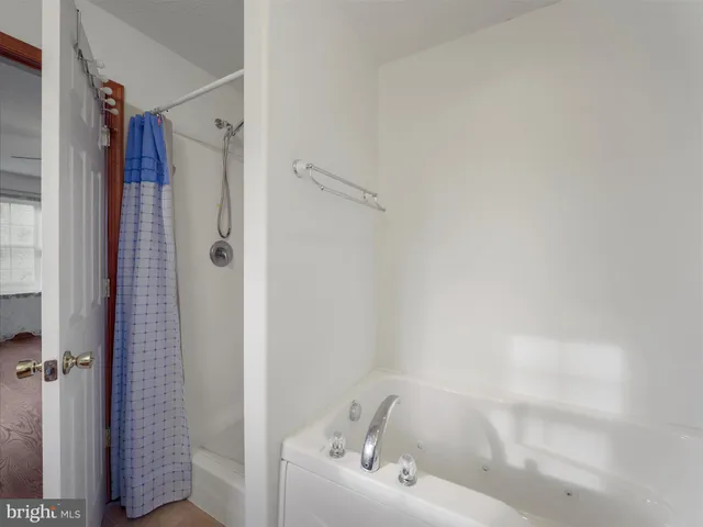 a bathroom with a bathtub and shower