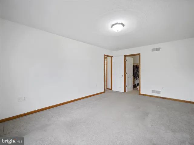 a view of an empty room and a window