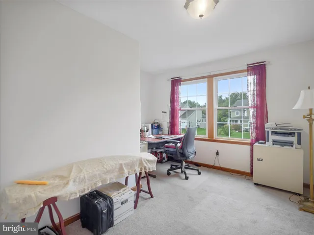 a bedroom with furniture and a large window