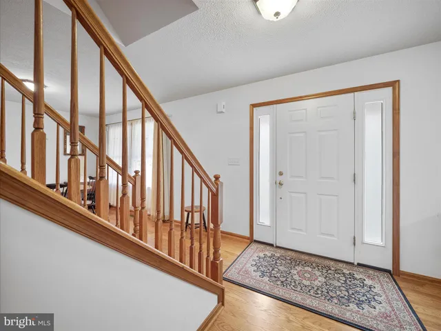 a view of an entryway with wooden floor