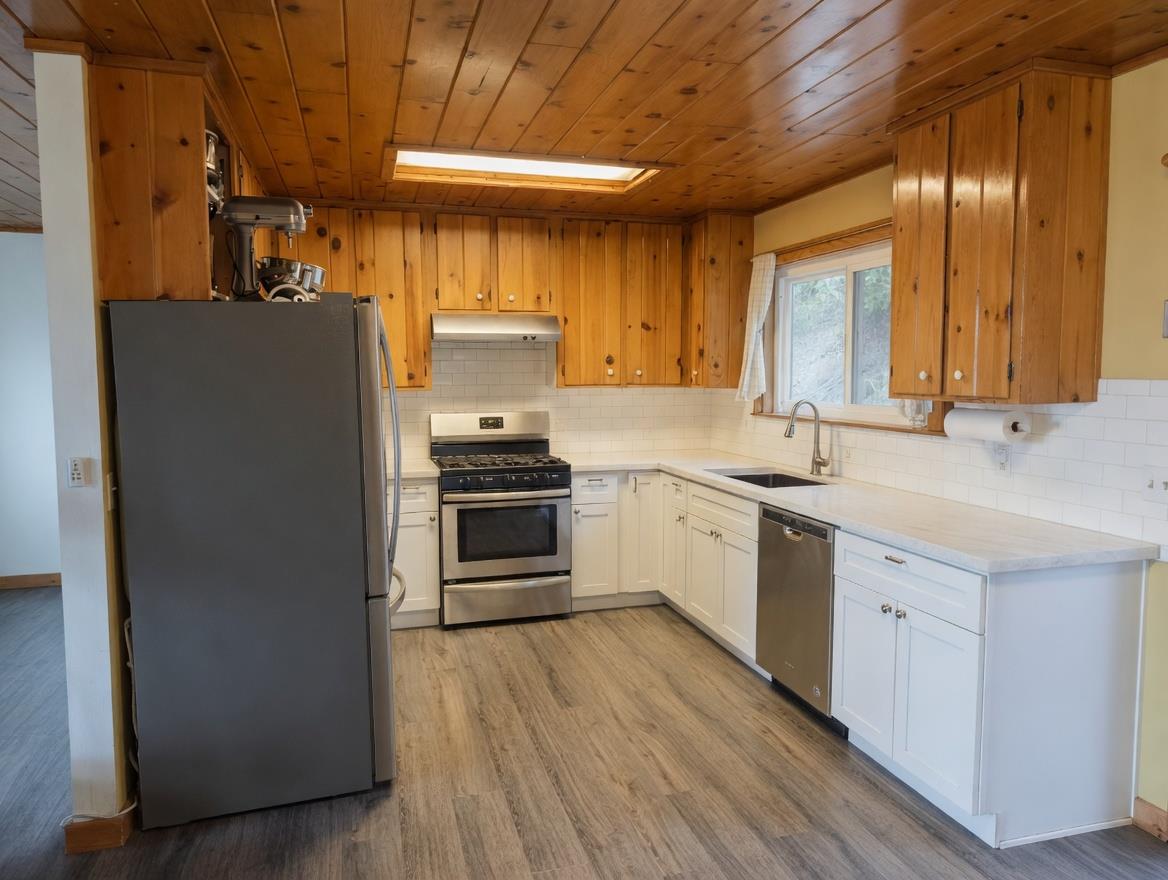 4850 8 Mile Road Camino, CA 95709 - Photo 9 of 30 a kitchen with a sink cabinets stainless steel appliances and a window