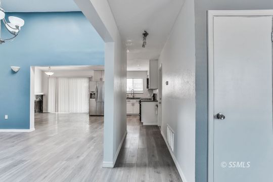515 South Downs Street Ridgecrest, CA 93555 - Photo 6 of 31 a view of a hallway with wooden floor and a bathroom