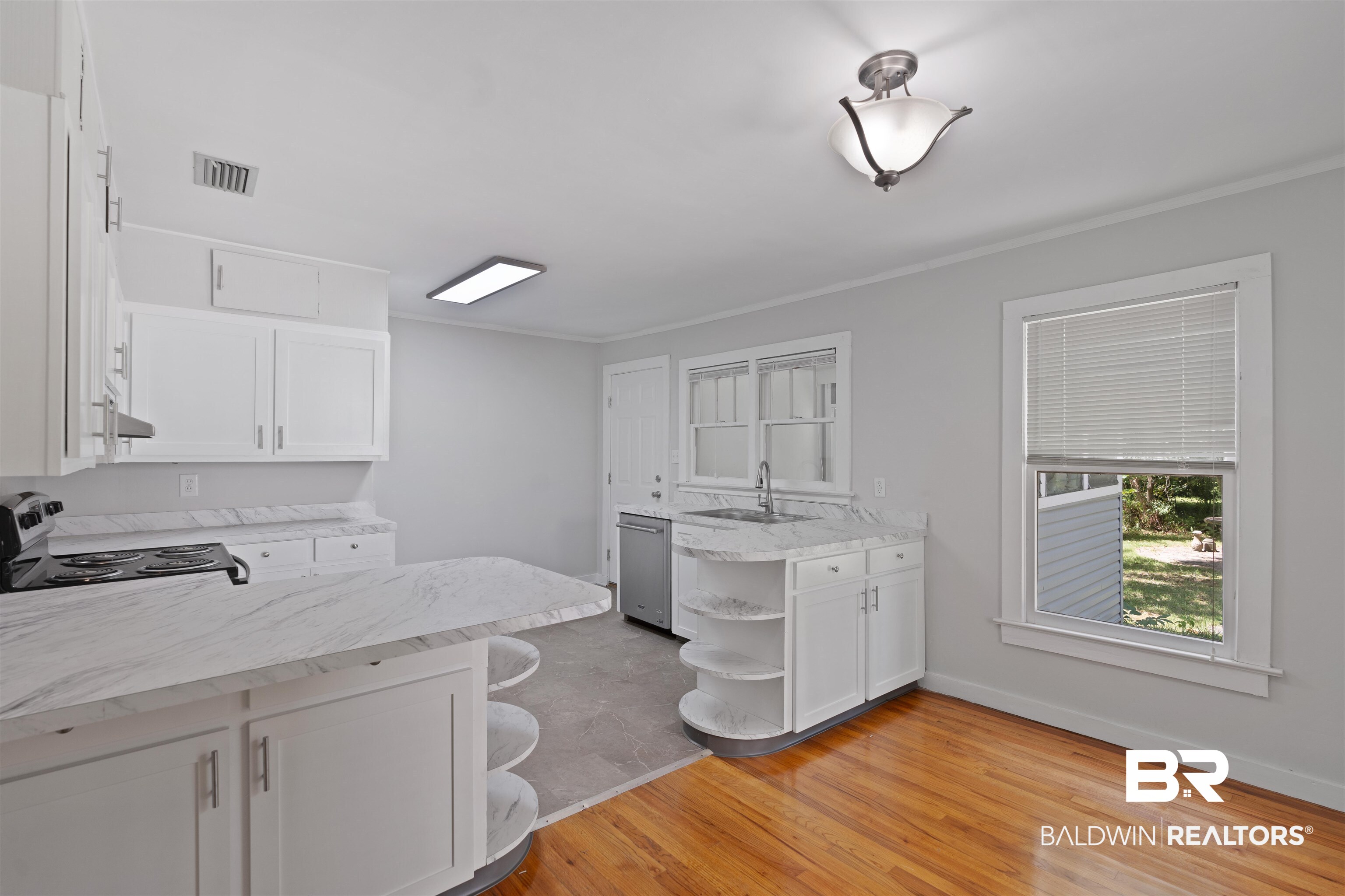 2126 Barron Place Mobile, AL 36605 - Photo 11 of 33 Kitchen featuring a kitchen bar, light wood-type flooring, stainless steel dishwasher, electric stove, and kitchen peninsula
