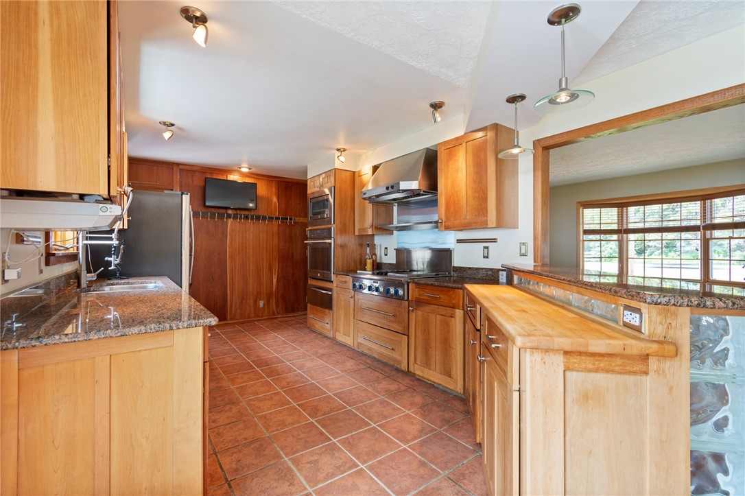 1213 State Road Webster, NY 14580 - Photo 12 of 38 Granite counters and wine storage in this custom k