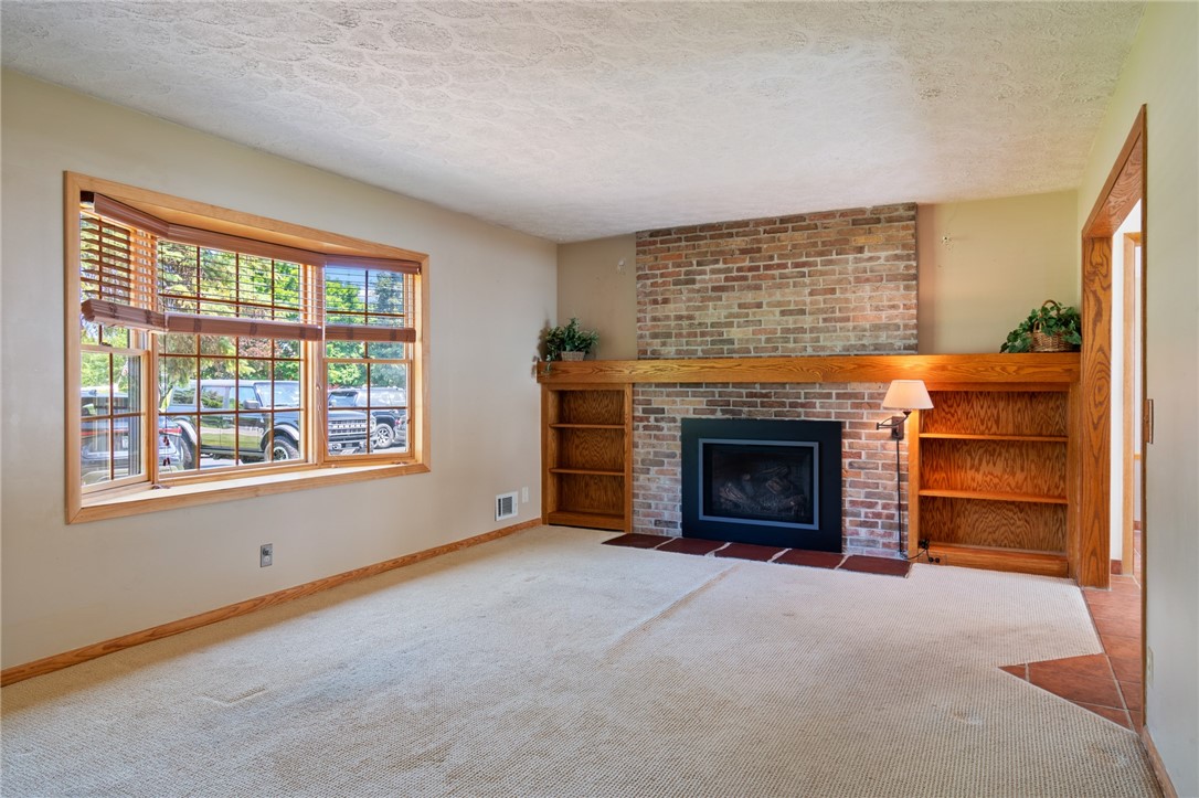 1213 State Road Webster, NY 14580 - Photo 20 of 38 The living room- the fireplace is a nice touch!