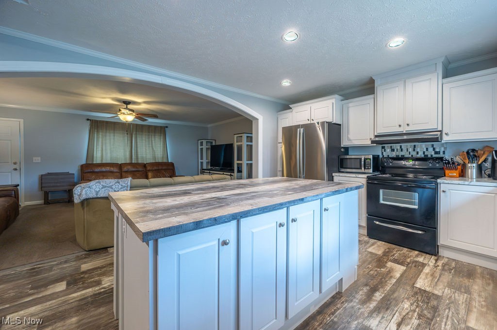 560 Wine Road Elizabeth, WV 26143 - Photo 50 of 50 Kitchen with arched walkways, white cabinetry, ornamental molding, stainless steel appliances, and open floor plan