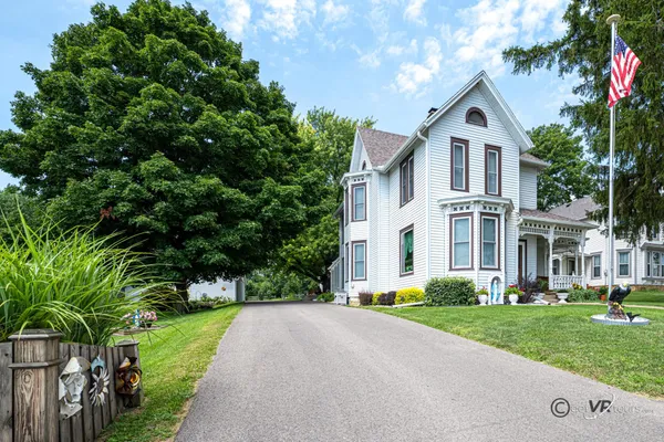 a view of a dining room with furniture a chandelier and wooden floor