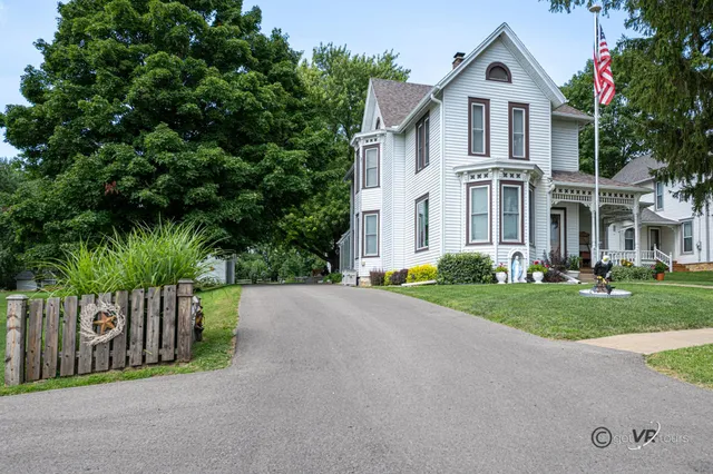 an aerial view of a house with swimming pool garden and lake view