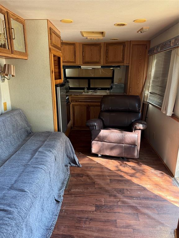 1046 East Owings Street Denison, TX 75021 - Photo 2 of 7 a bedroom with bed and wooden floor