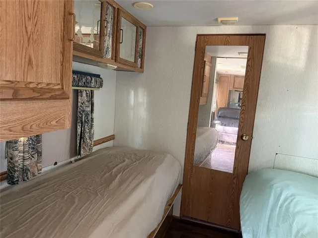 a bedroom with a bed and a mirror