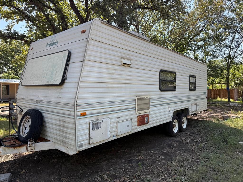 1046 East Owings Street Denison, TX 75021 - Photo 6 of 7 a view of a white house with a big yard and large tree