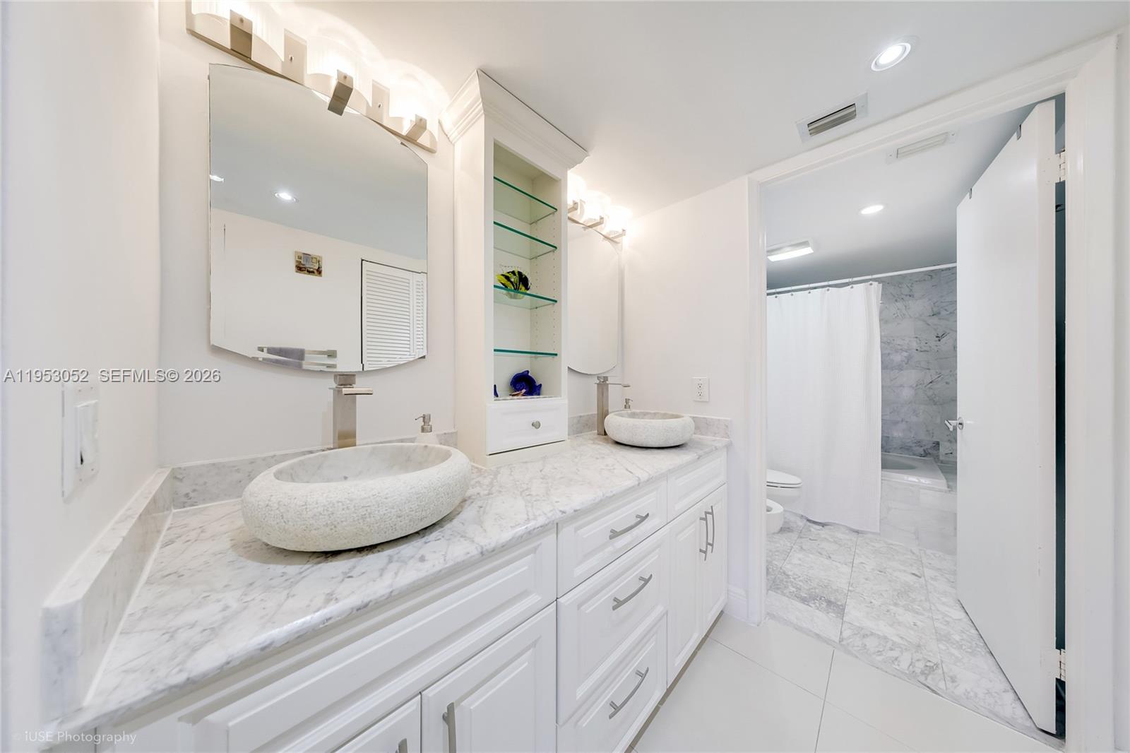9341 Collins Avenue, Unit 503 Surfside, FL 33154 - Photo 15 of 35 a bathroom with a granite countertop sink and a mirror