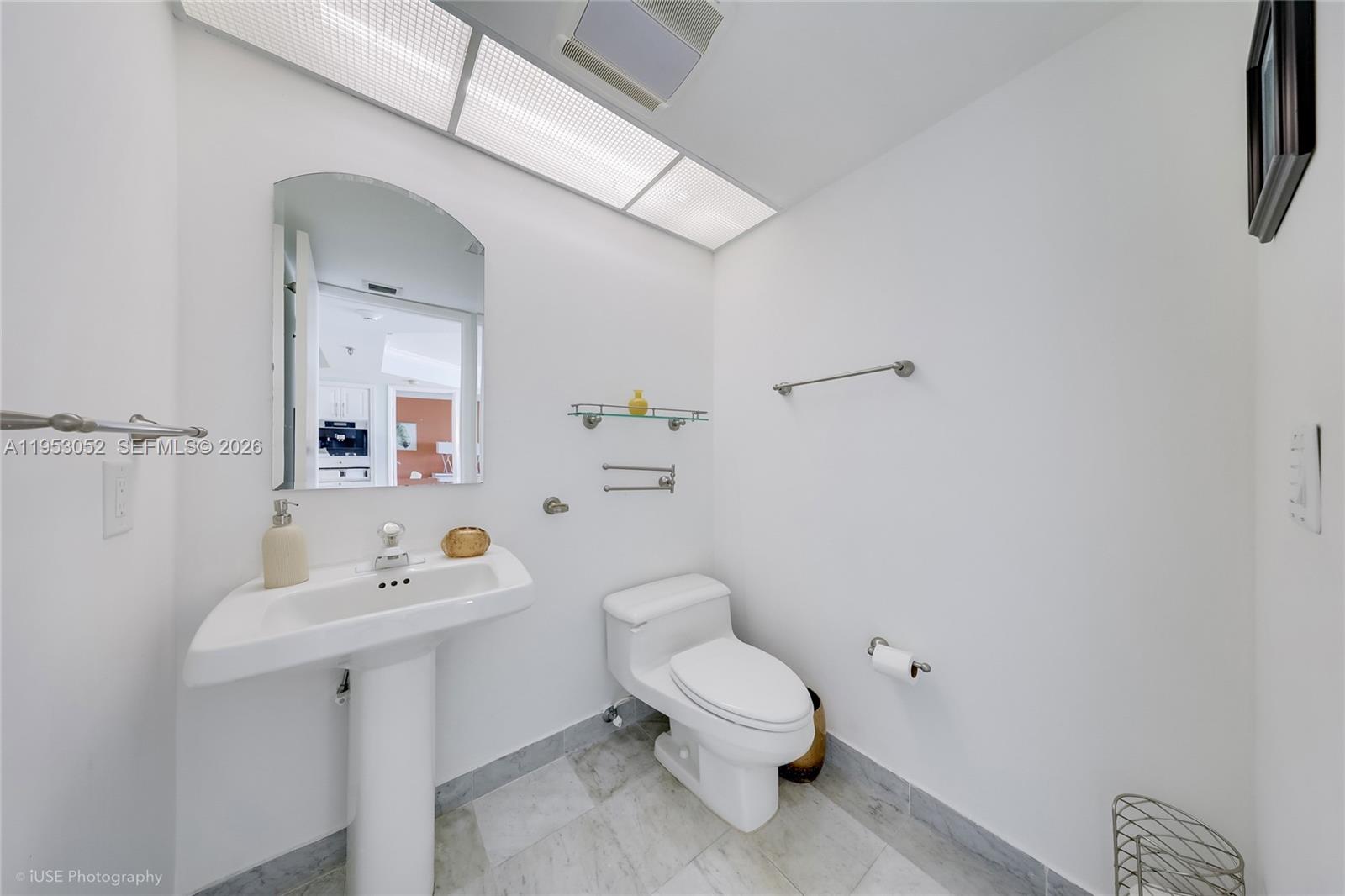 9341 Collins Avenue, Unit 503 Surfside, FL 33154 - Photo 7 of 35 a white toilet sitting next to a bathroom sink