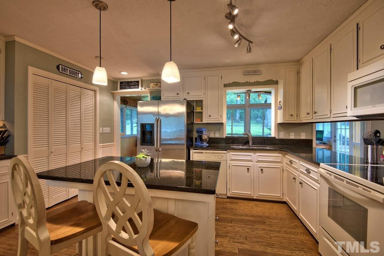 208 Latta Road Durham, NC 27712 - Photo 11 of 25 The island and storage are super convenient.