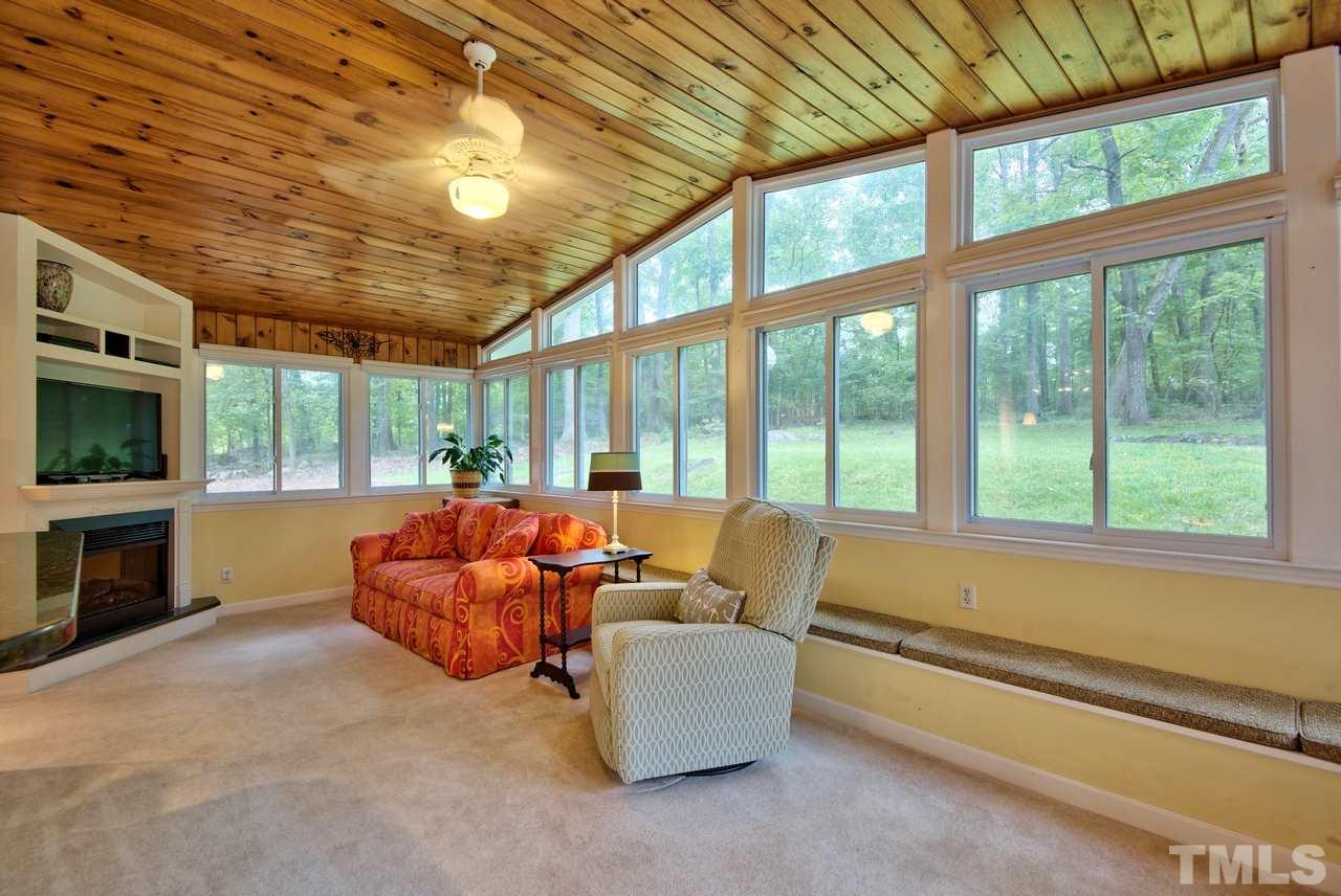 208 Latta Road Durham, NC 27712 - Photo 13 of 25 The Sun Room has an electric fireplace.