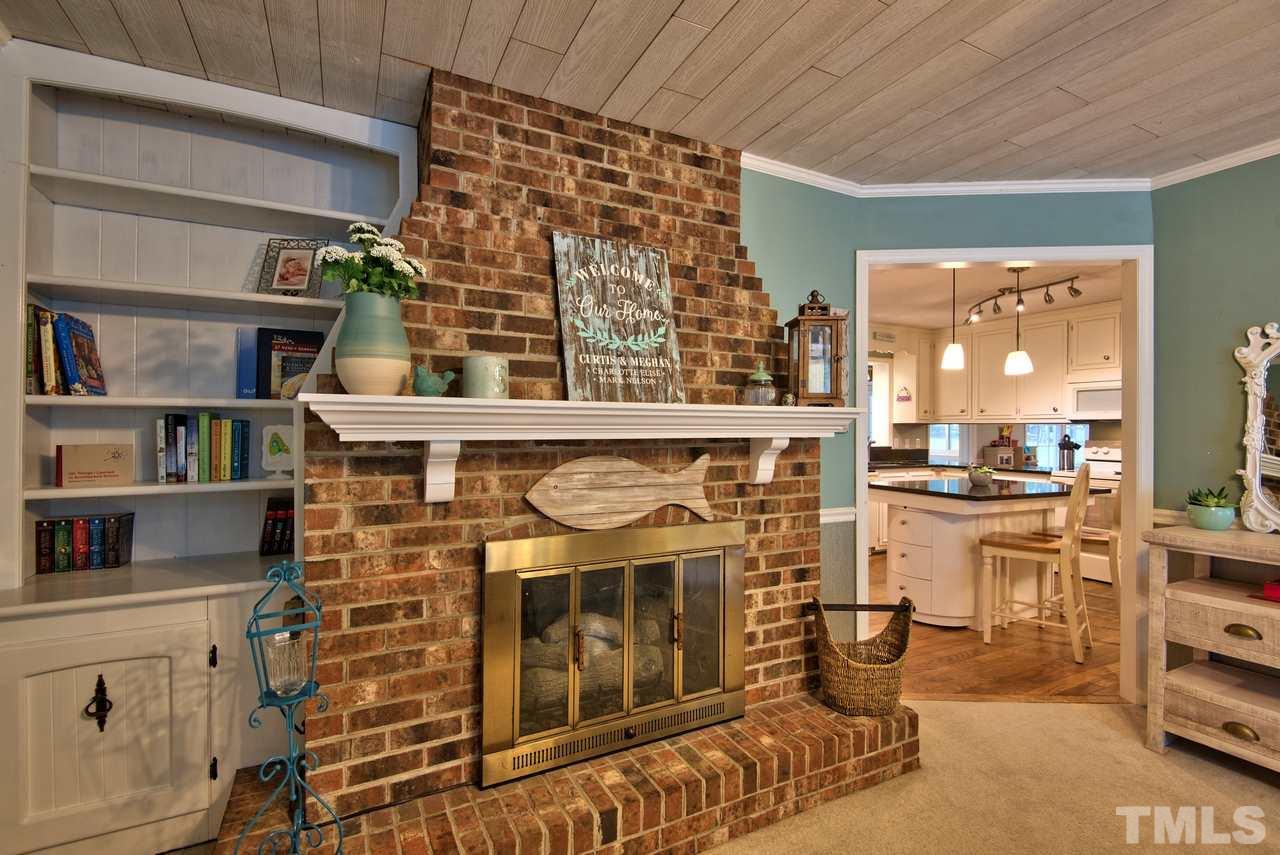 208 Latta Road Durham, NC 27712 - Photo 7 of 25 The Family Room features a Fireplace that has Gas Logs and built in shelving beside it.