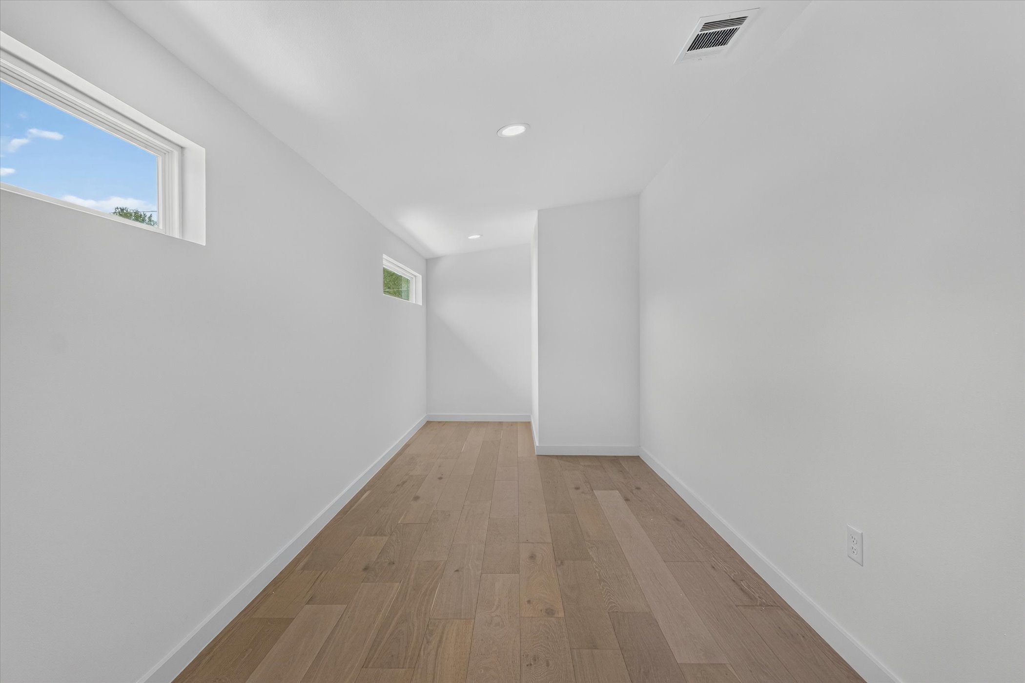 5305 Ledesma Road, Unit 1 Austin, TX 78721 - Photo 32 of 37 Minimalist design shines with smooth plaster walls, recessed lights, and rich hardwood flooring.