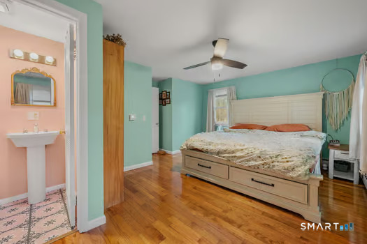 9 Thompson Road Franklin, CT 06254 - Photo 19 of 30 a bedroom with a bed and wooden floor