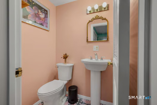 9 Thompson Road Franklin, CT 06254 - Photo 21 of 30 a bathroom with a toilet sink and mirror