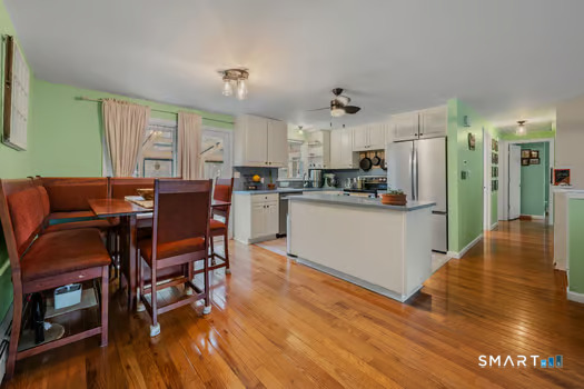 9 Thompson Road Franklin, CT 06254 - Photo 5 of 30 a kitchen with stainless steel appliances wooden floor and dining table