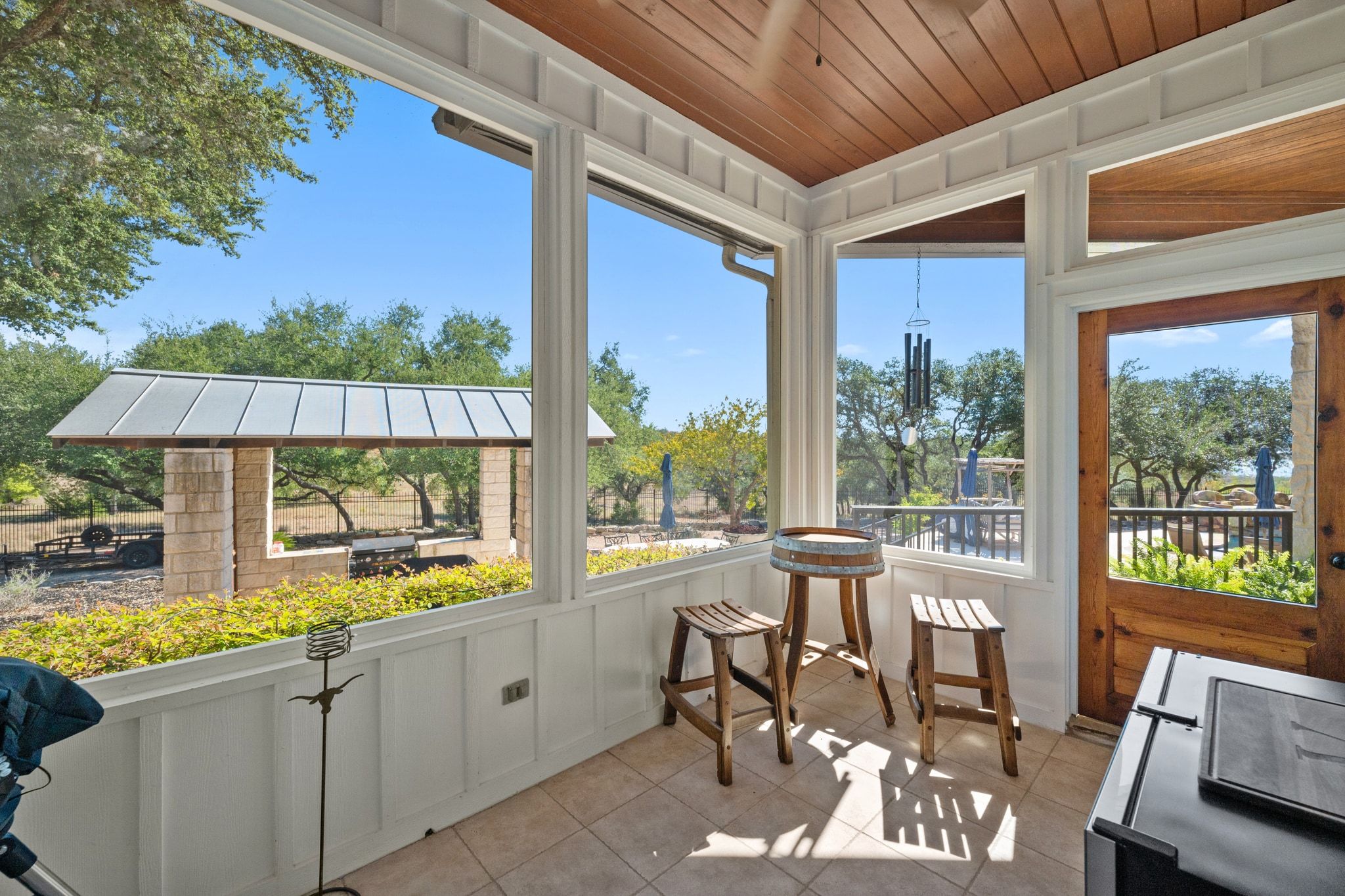 185 Shimmering Shore Court Spring Branch, TX 78070 - Photo 11 of 36 Sunroom / solarium featuring tile patterned floors, wooden ceiling, and a decorative wall