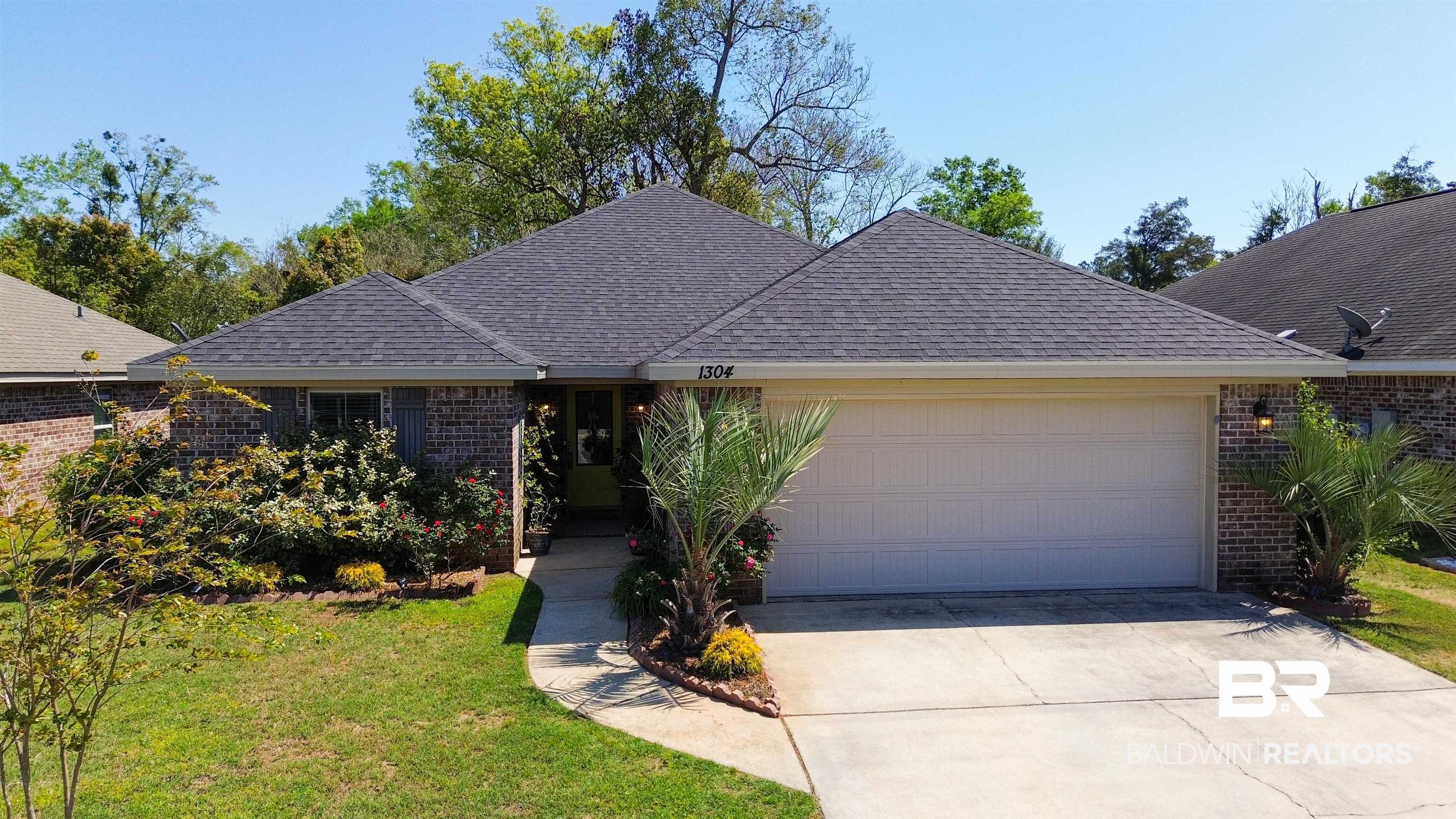 1304 Majesty Loop Foley, AL 36535 - Photo 1 of 44 Ranch-style house with an attached garage, brick siding, a front lawn, concrete driveway, and a shingled roof