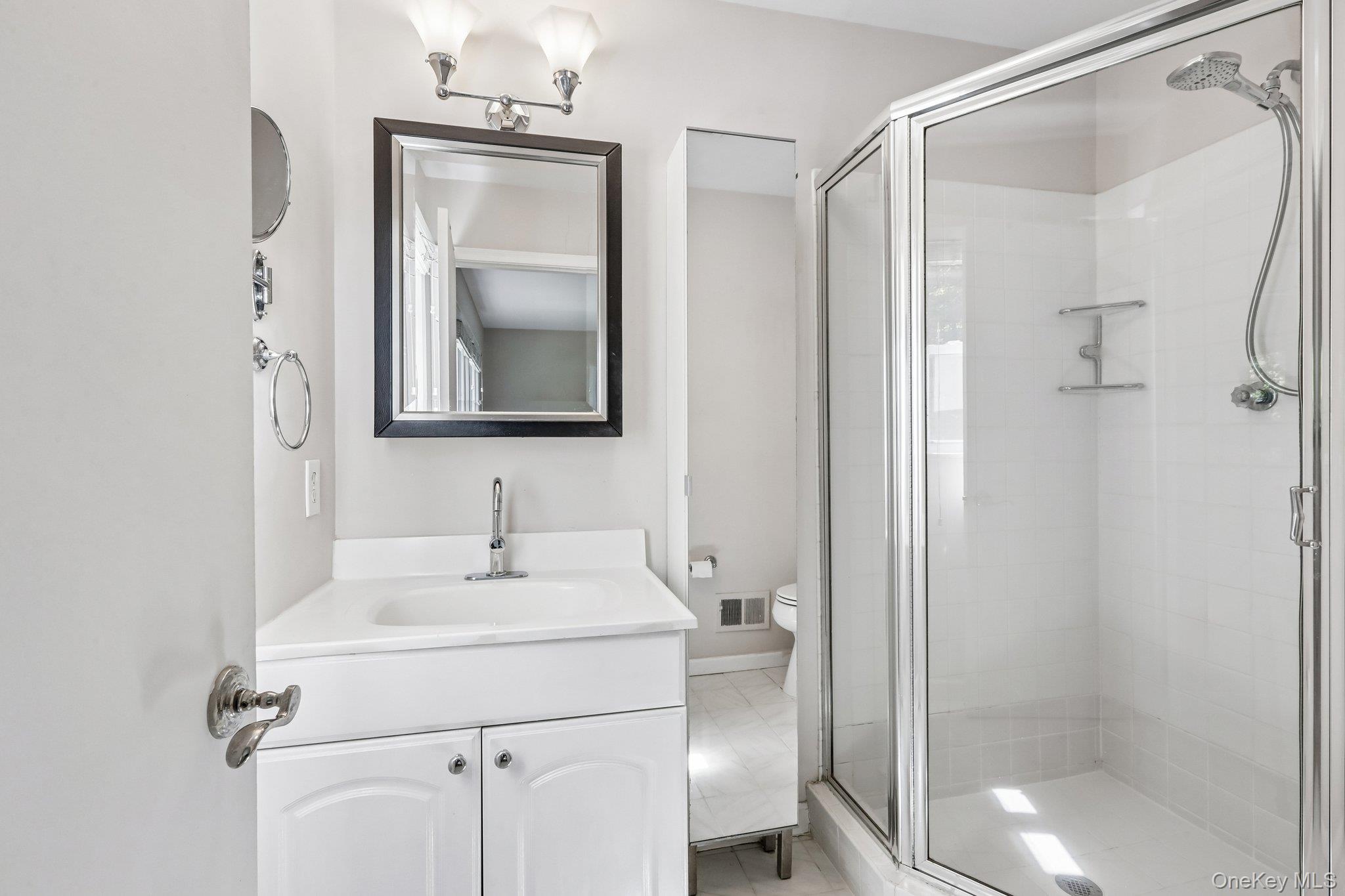 62 Mohegan Road Larchmont, NY 10538 - Photo 40 of 46 a bathroom with a sink toilet and shower