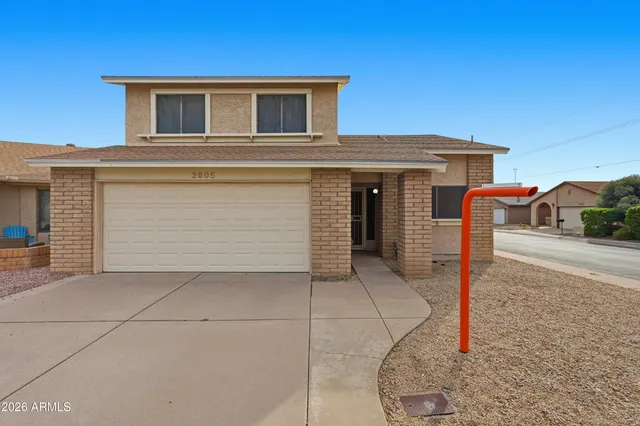 a front view of a house with parking space