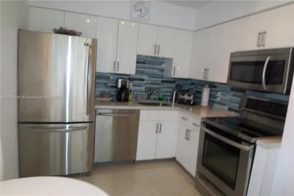 a kitchen with a refrigerator stove and microwave
