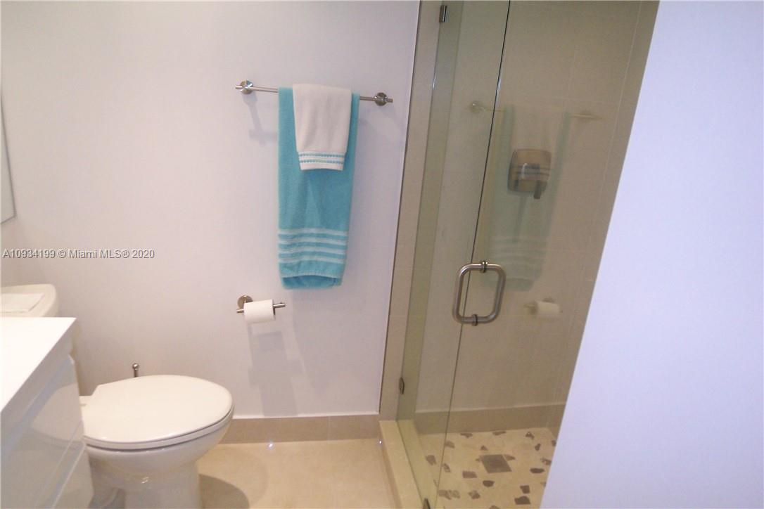 5161 Collins Avenue, Unit 806 Miami Beach, FL 33140 - Photo 17 of 52 a bathroom with a shower and toilet
