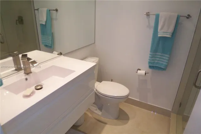 a bathroom with a sink a toilet and mirror