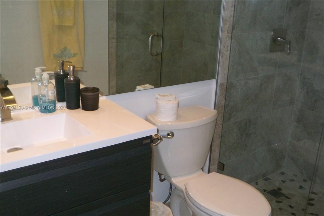 5161 Collins Avenue, Unit 806 Miami Beach, FL 33140 - Photo 19 of 52 a bathroom with a sink a toilet and shower