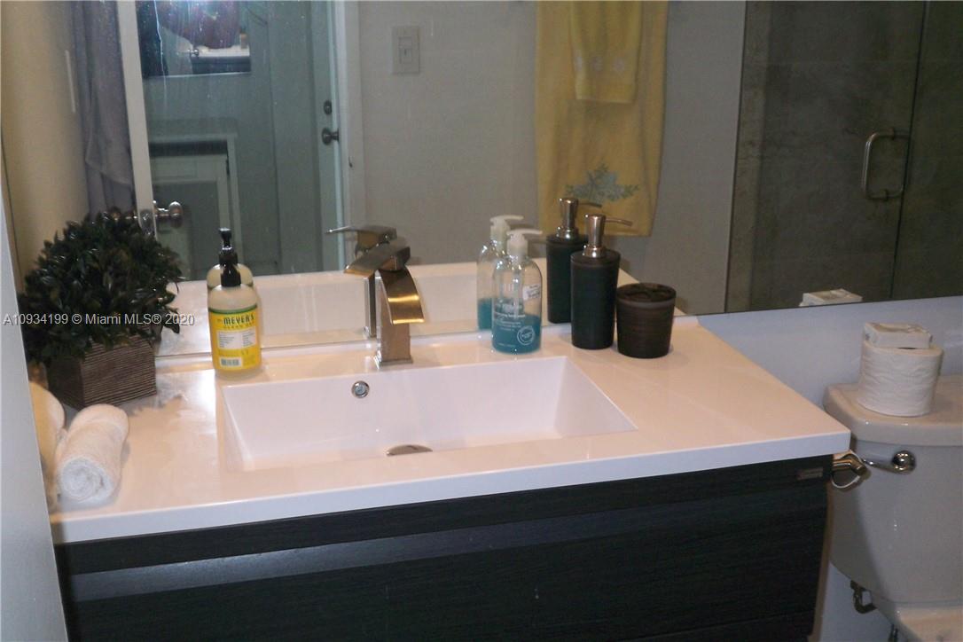 5161 Collins Avenue, Unit 806 Miami Beach, FL 33140 - Photo 21 of 52 a bathroom with a sink and a mirror