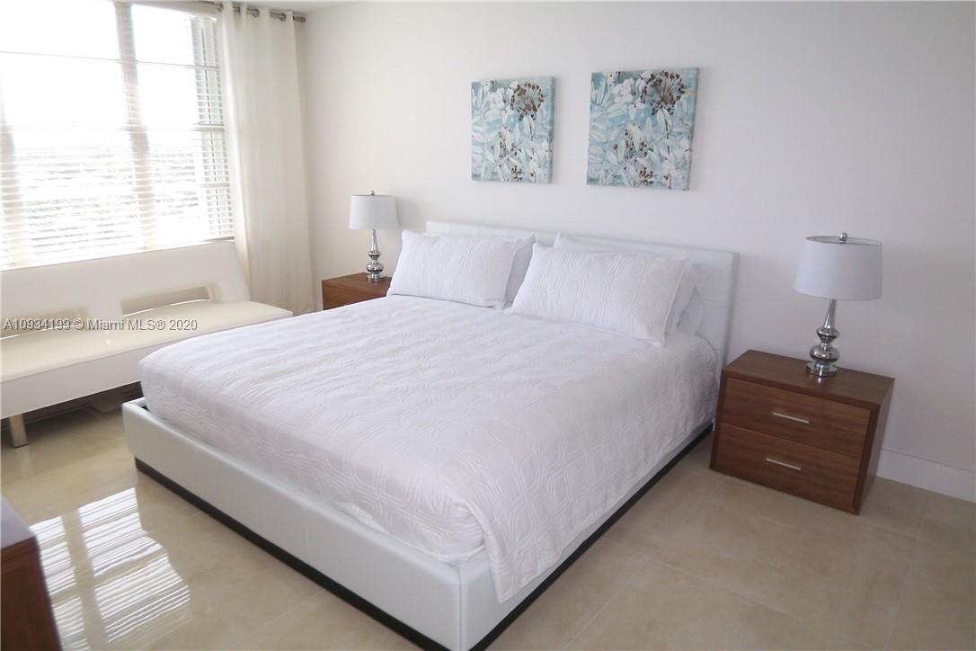5161 Collins Avenue, Unit 806 Miami Beach, FL 33140 - Photo 22 of 52 a bedroom with a bed and a window