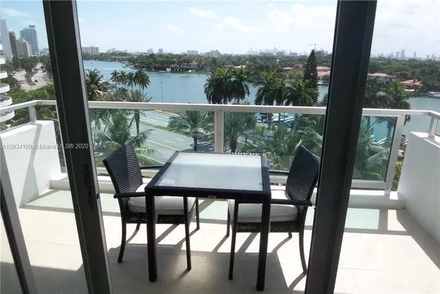 a view of a chair and table in the balcony